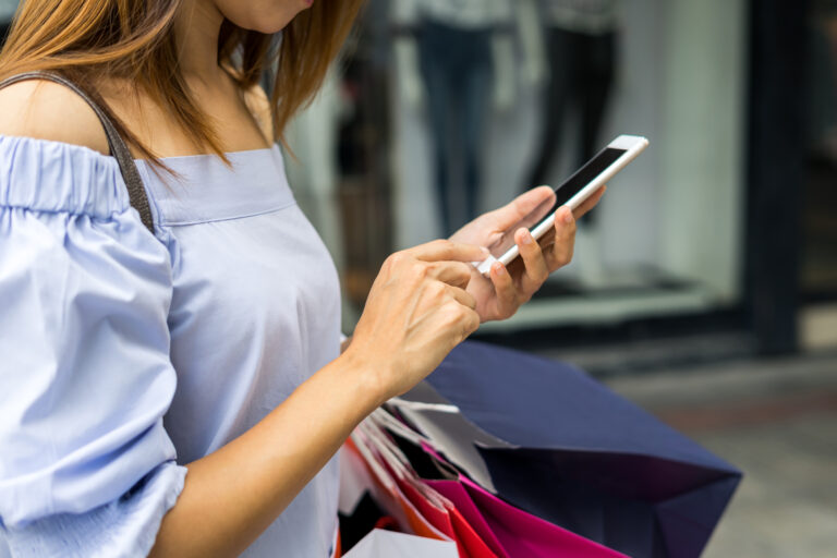 Young woman with shopping bags in the shop