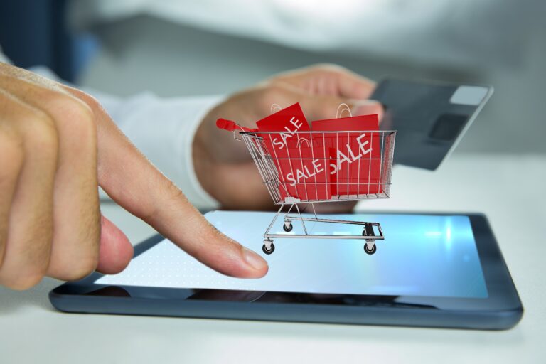 Composite image of hand using tablet computer for  buy with the credit card
